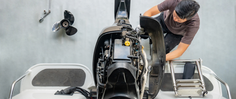 Automotive technician working on a motorboat engine