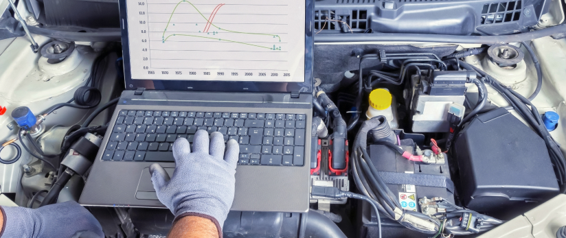 Automotive technician working on a car engine