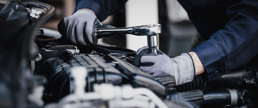 Mechanic working on car engine